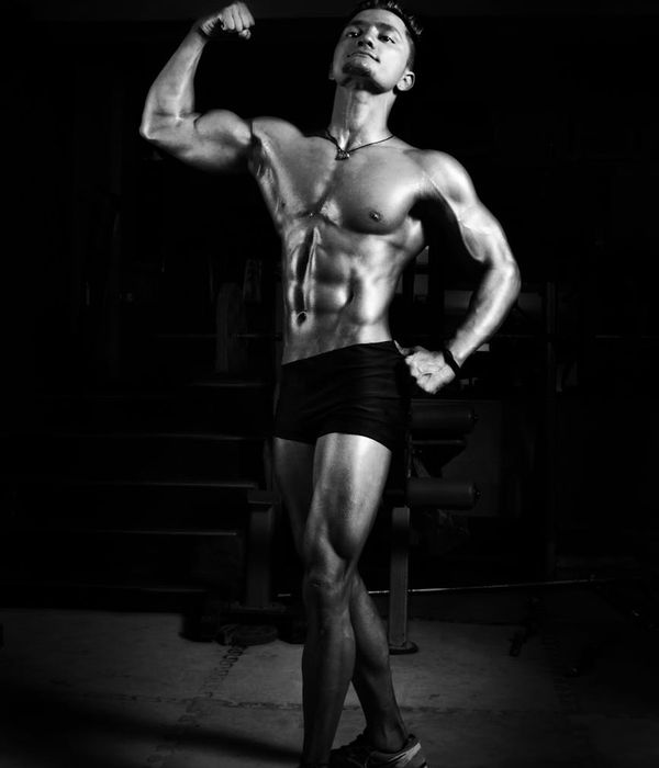 Man in a powerful yoga warrior pose with a look of intense focus.